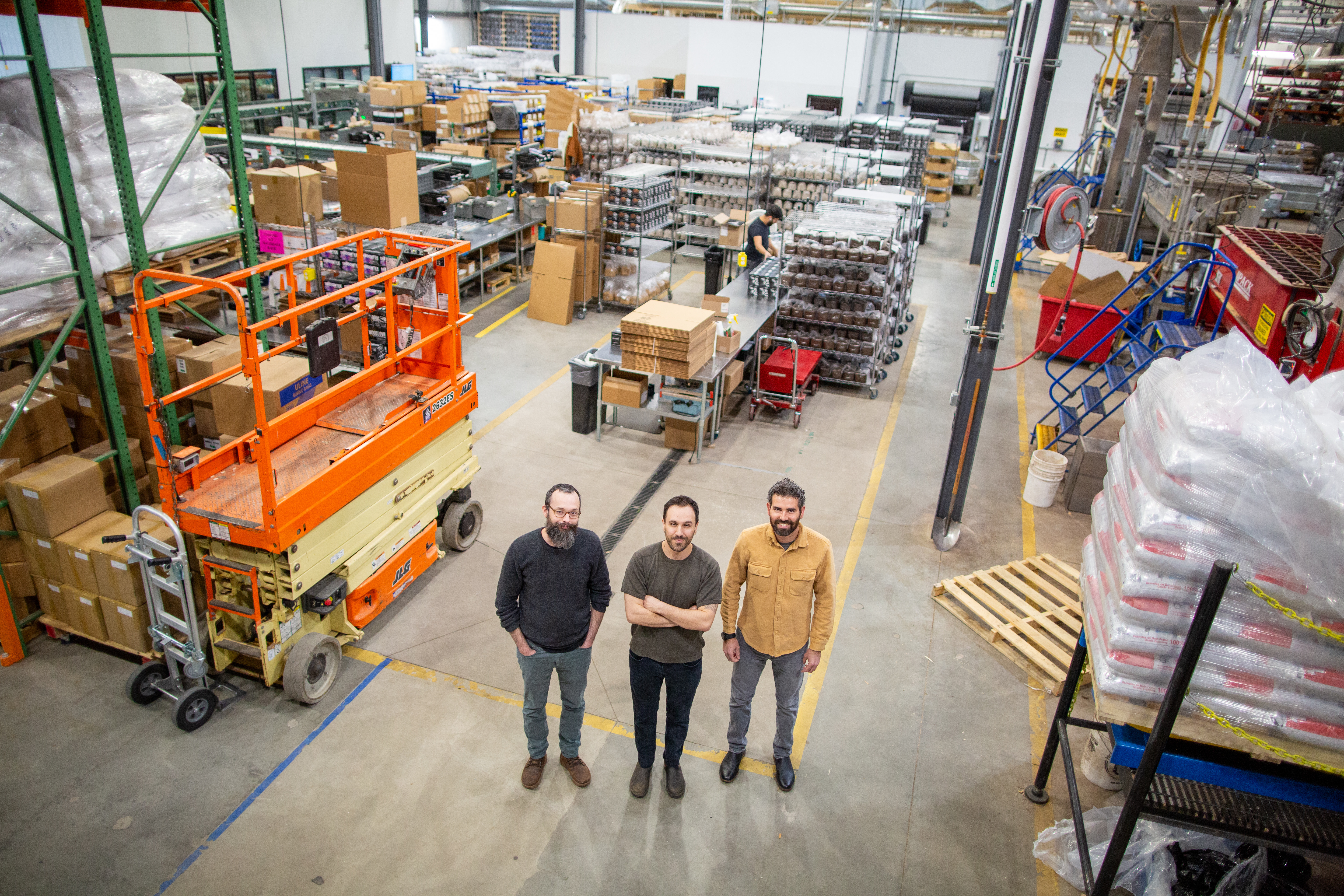 North Spore co-founders Jon Carver, Matt McInnis, and Eliah Thanhauser standing in the Portland production facility