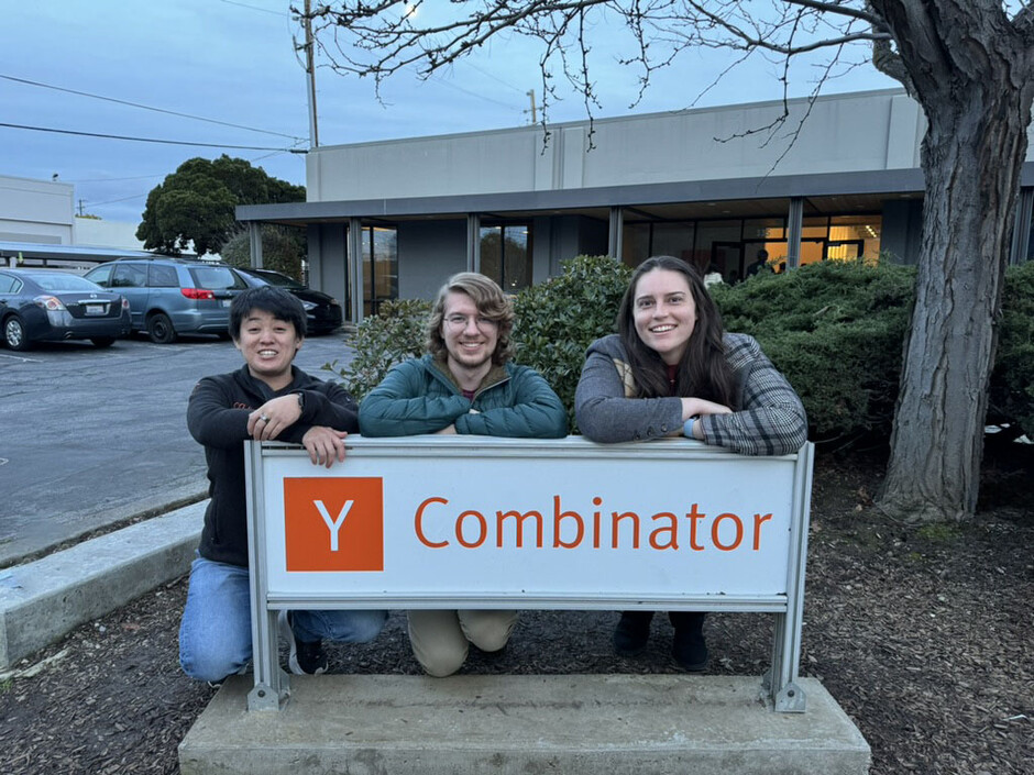 Ellen Hui, John Stimac, and Dori Wilson behind a Y Combinator sign