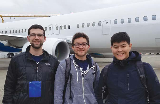 Elliot Margul, Cody Morris and Frankie Angai standing together in front of an aircraft in 2016