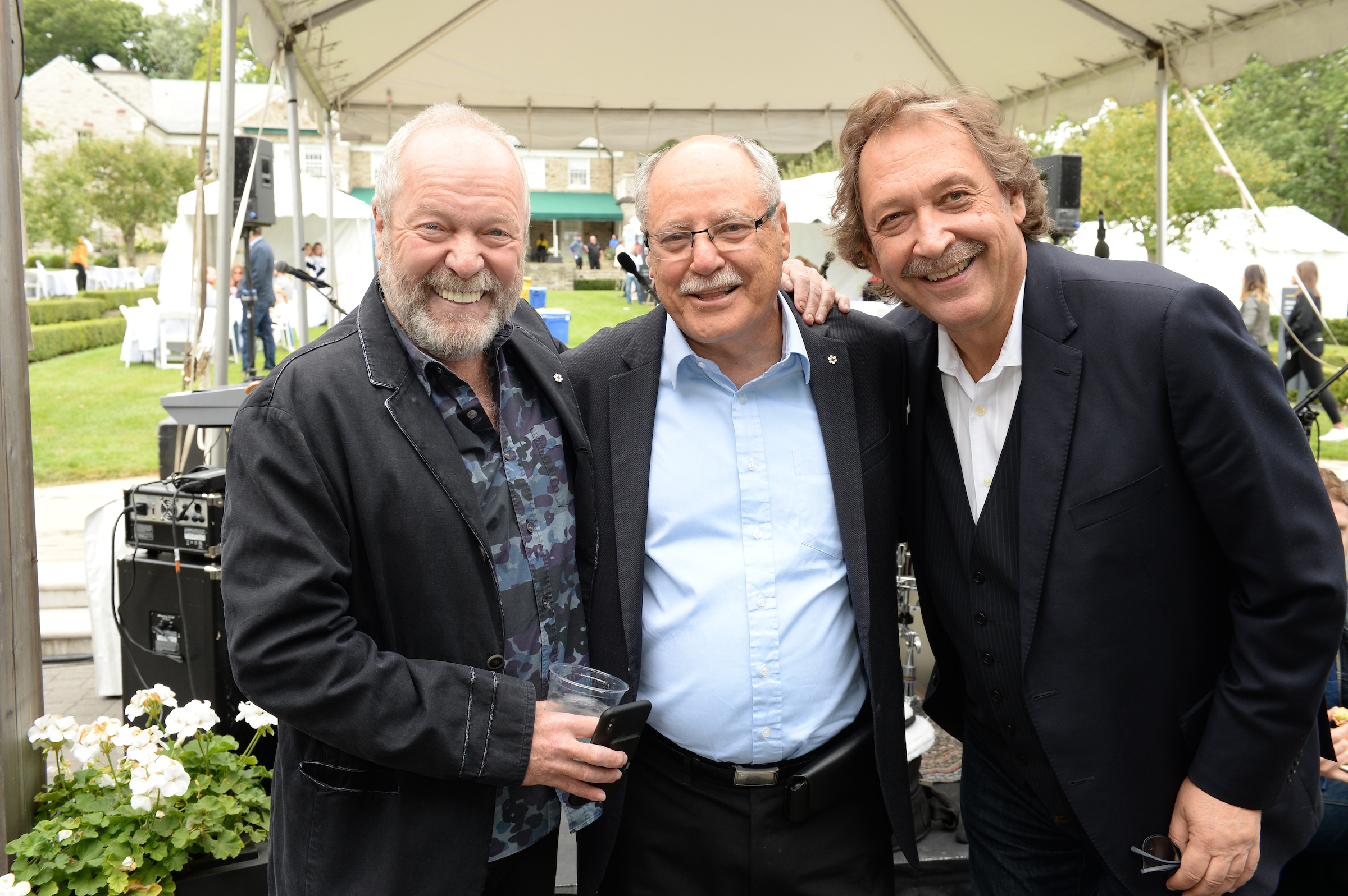 Gary Slaight, Ellis Jacob and Slawko Klymkiw smiling at the Canadian Film Centre’s outdoor fundraiser