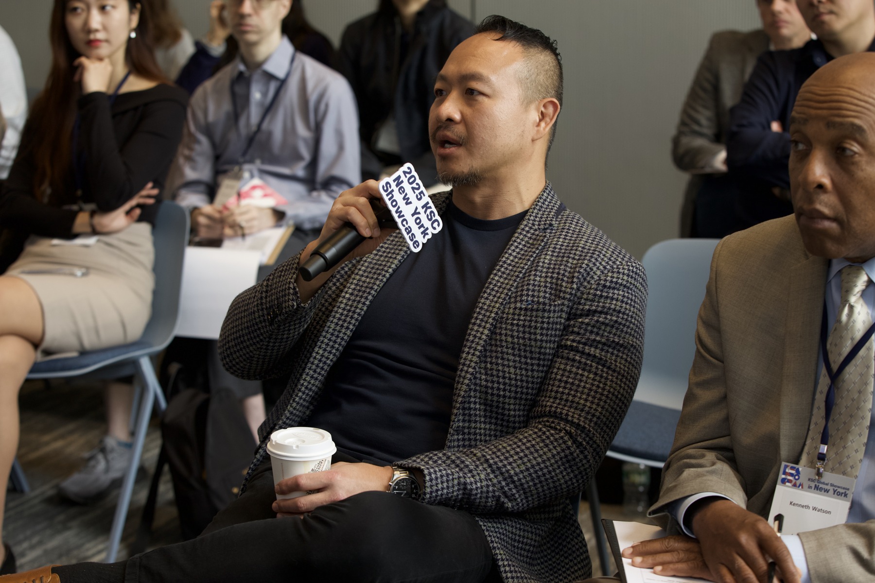 A participant speaks into a microphone at the 2025 KSC New York showcase