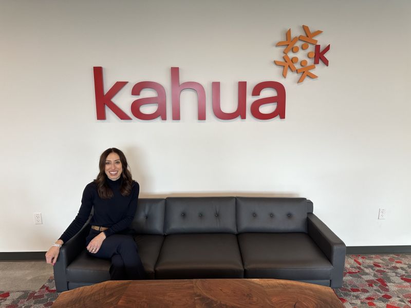 Elyssa Steiner seated beneath the Kahua sign on her first day as Chief Marketing Officer