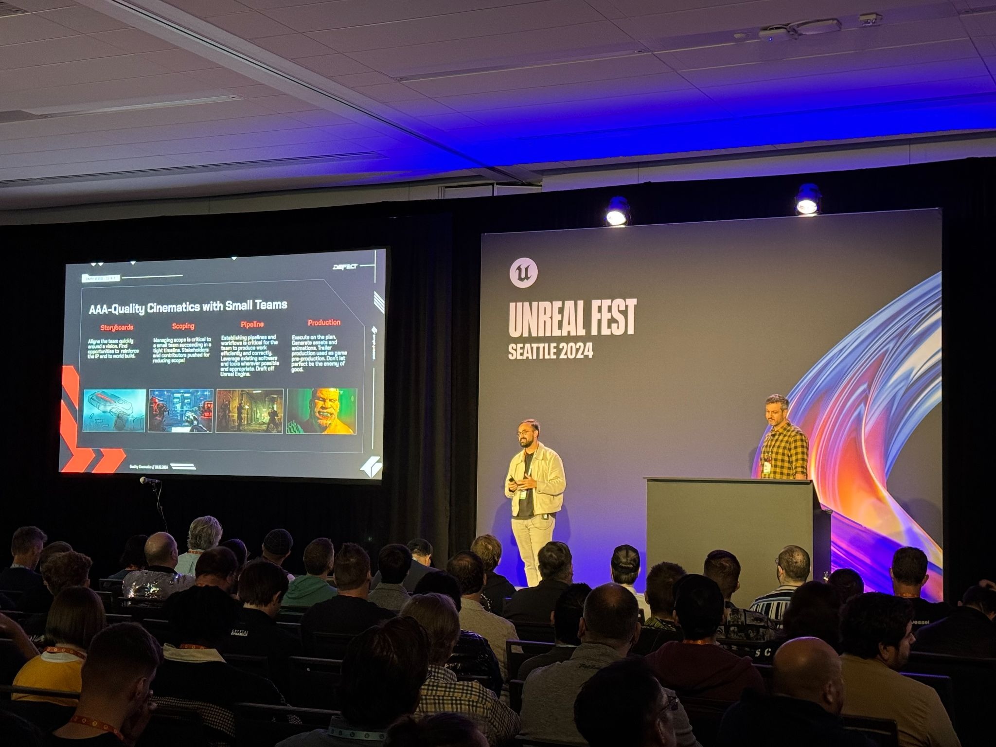 Two presenters onstage at Unreal Fest Seattle 2024 beside a slide about making cinematics with small teams