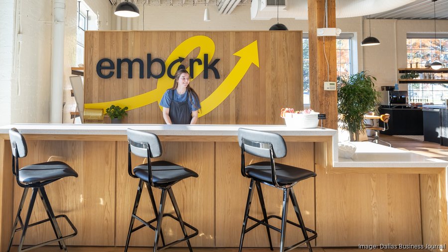 A staff member behind the reception counter in Embark’s light-filled Dallas office