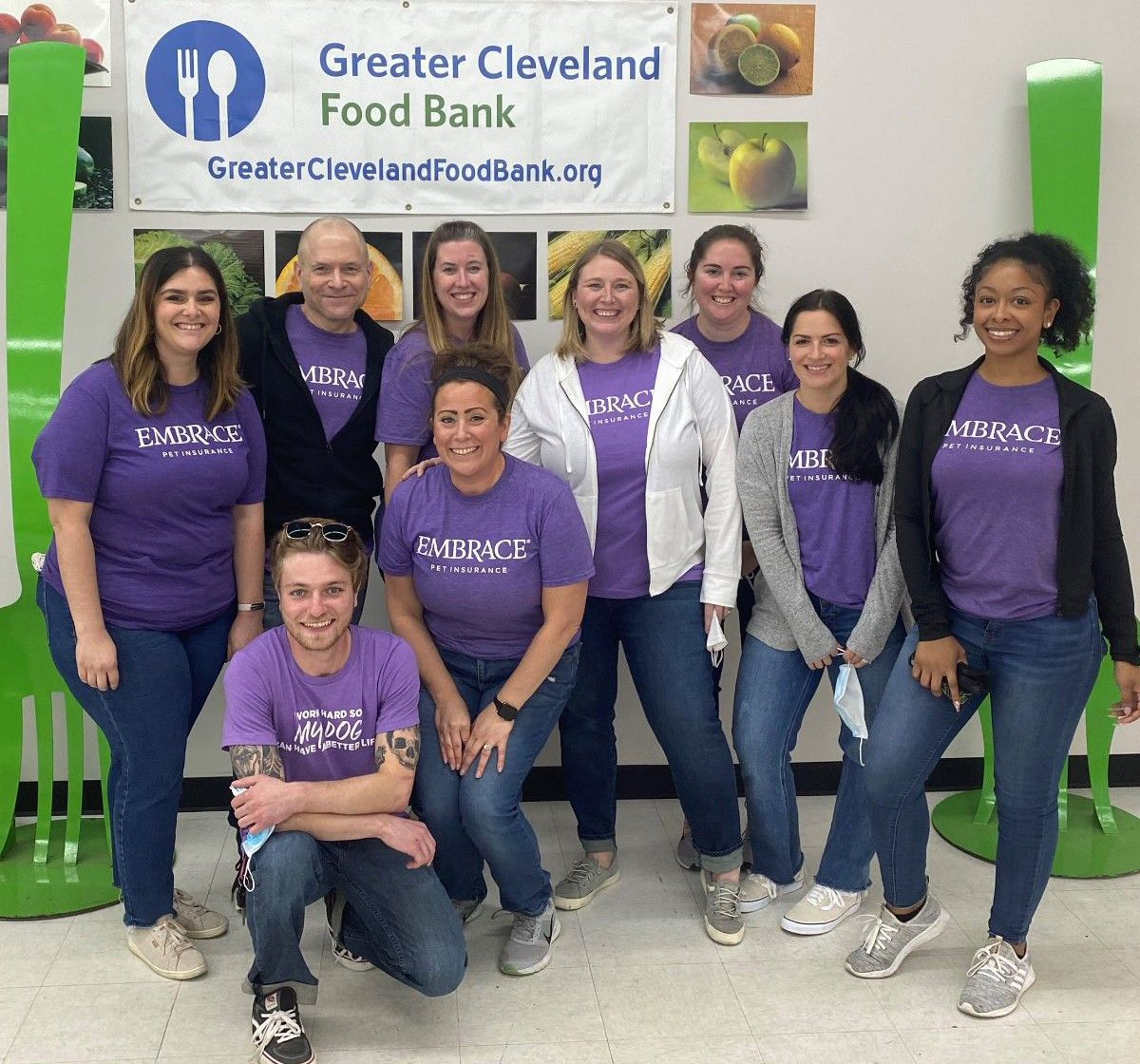 Embrace employees in purple company shirts at the Greater Cleveland Food Bank