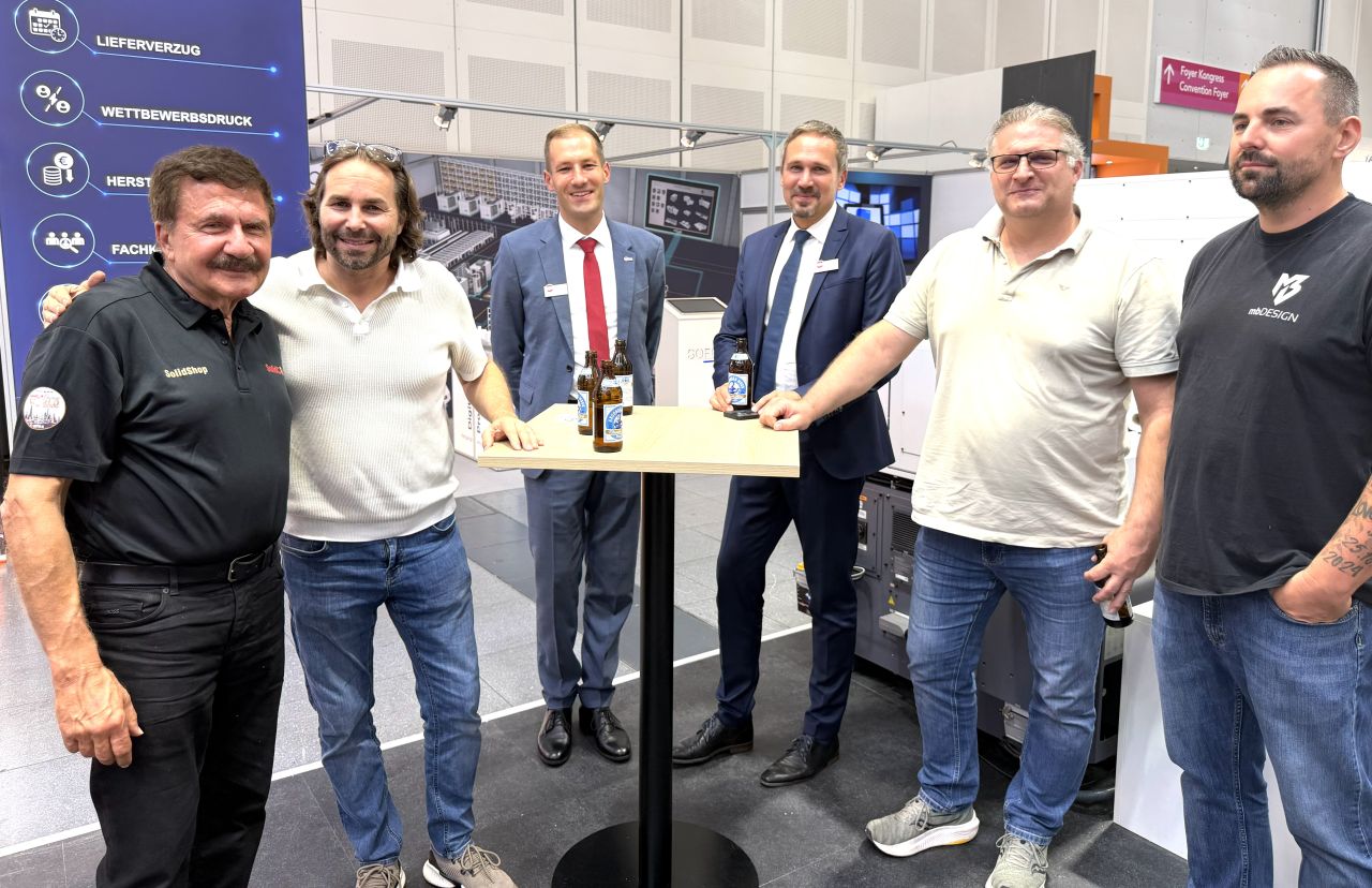 Emil Somekh at left with partners and visitors at the SolidCAM stand at AMB 2026