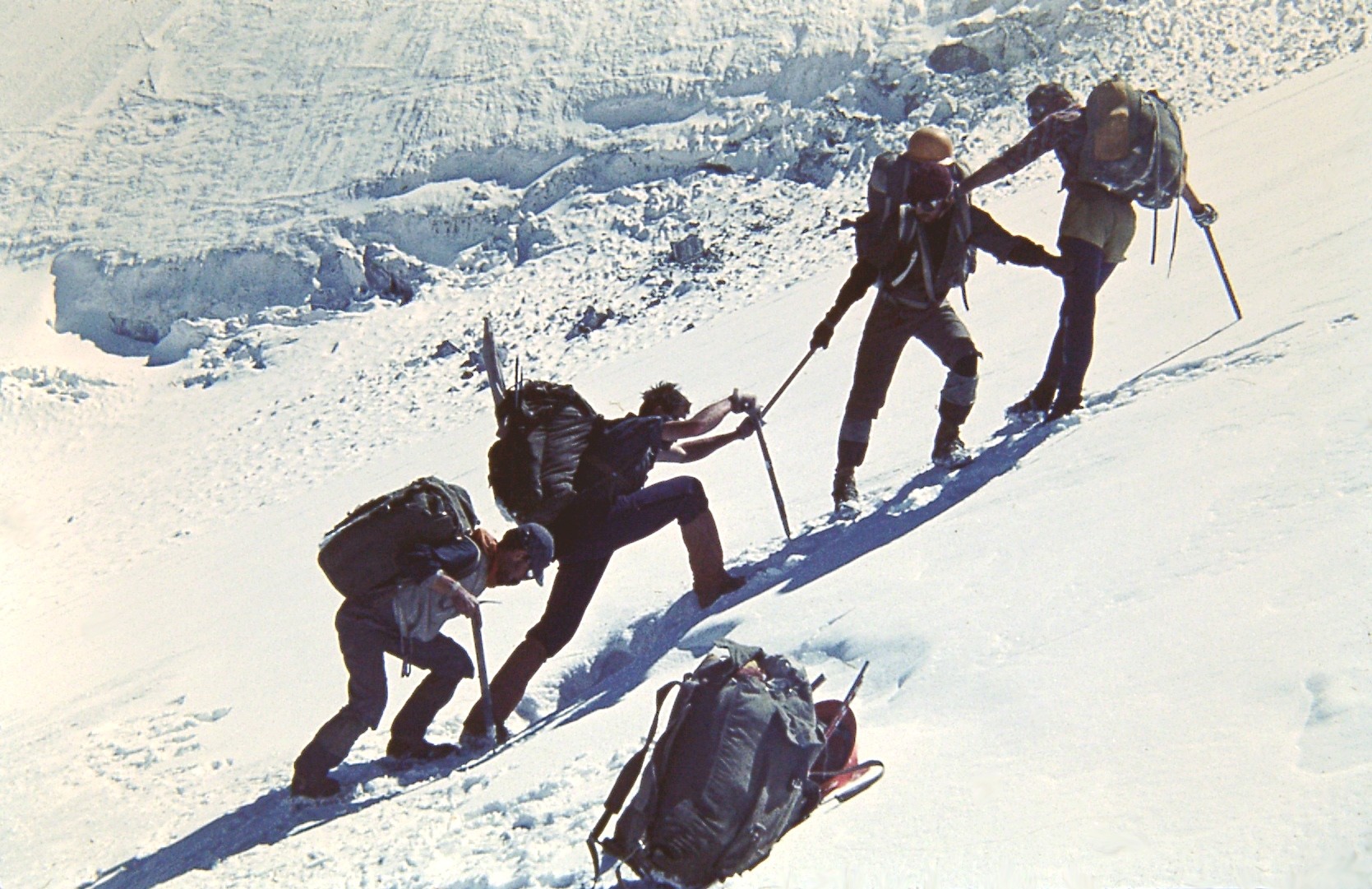 Four climbers ascend a snowy slope in the Pamirs in 1978; Emil Yakupov is second from the right