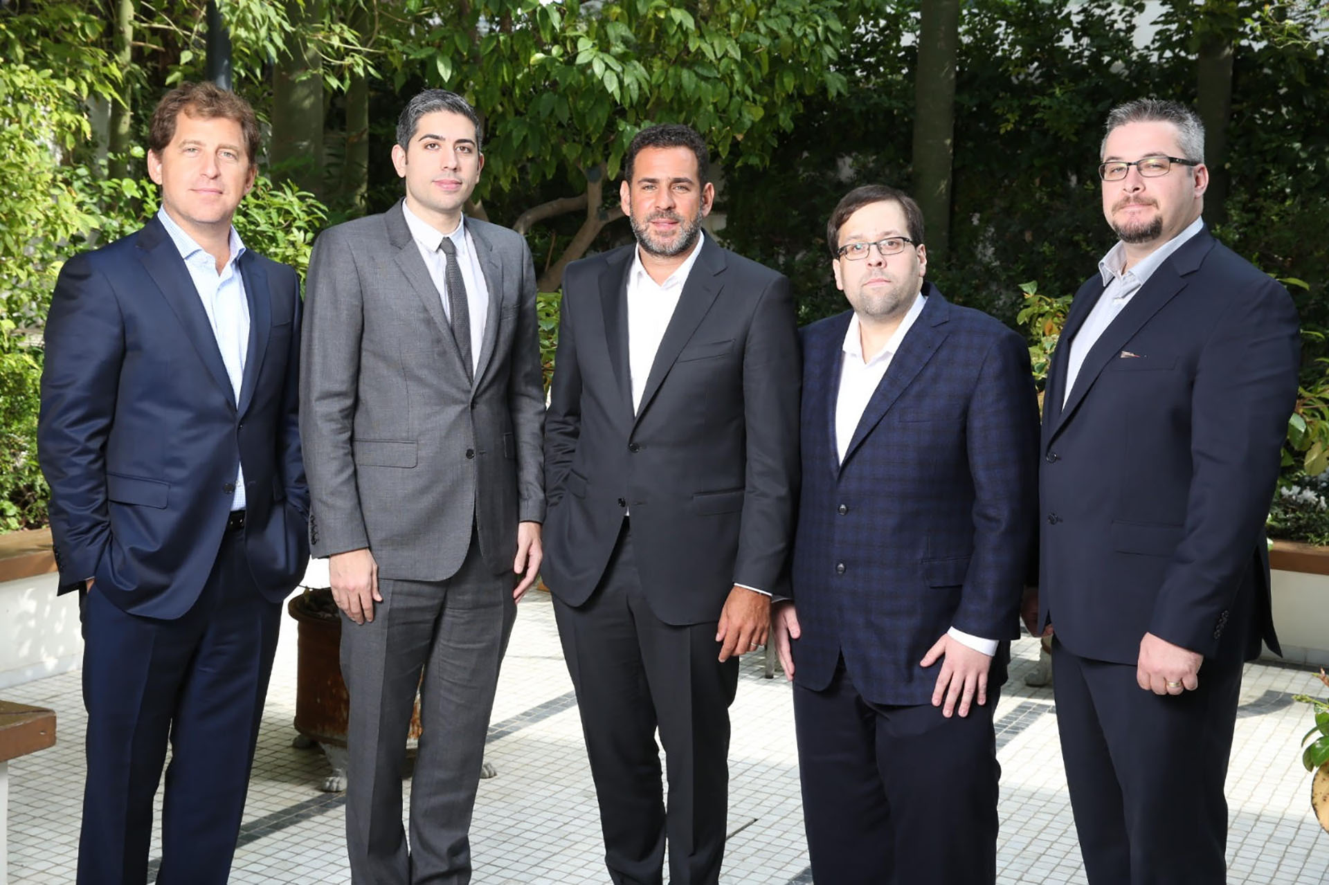 Early Bitfarms partners standing together outdoors, with Emiliano Grodzki in the centre