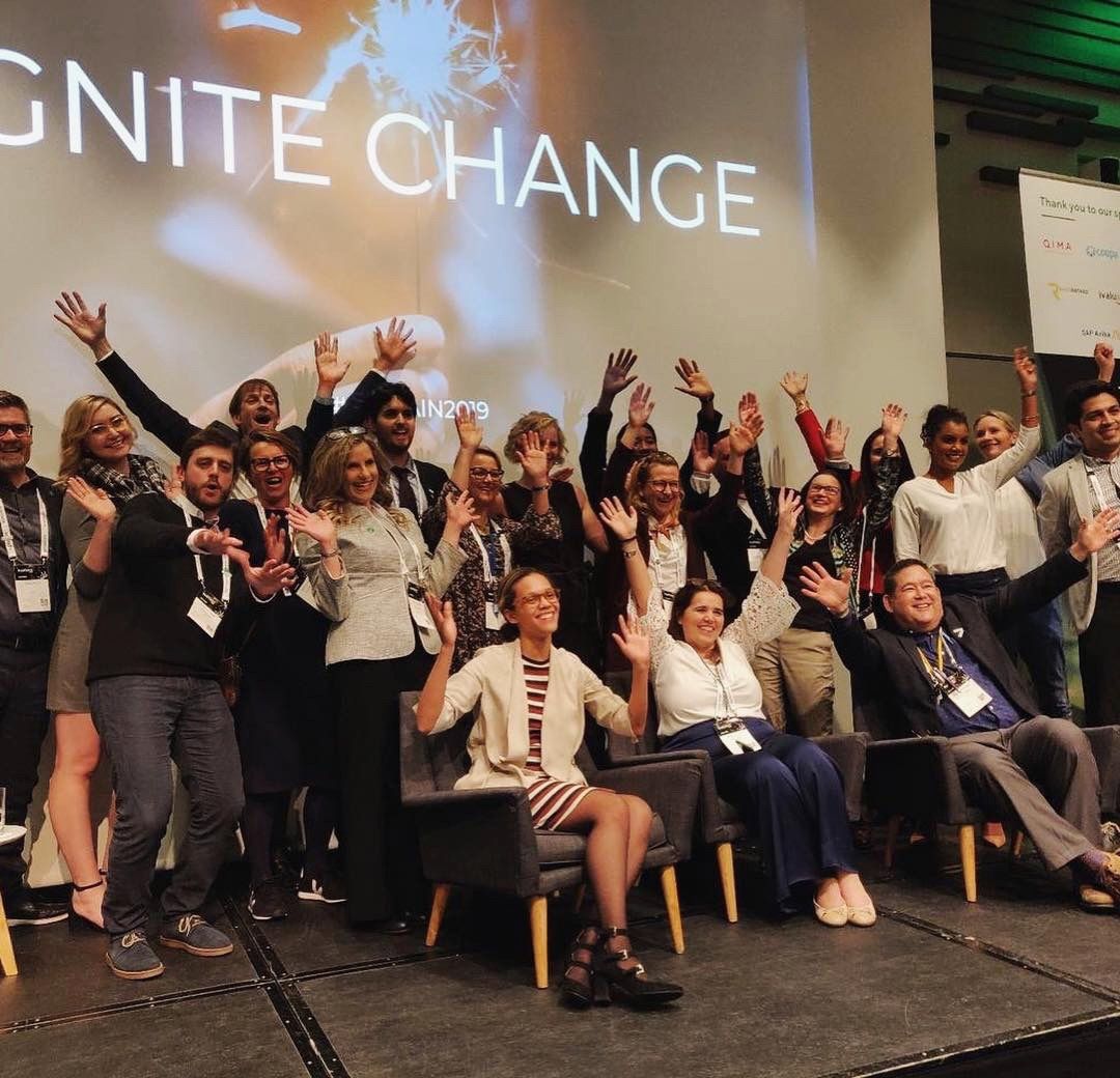 The EcoVadis team celebrating together onstage at a SUSTAIN event