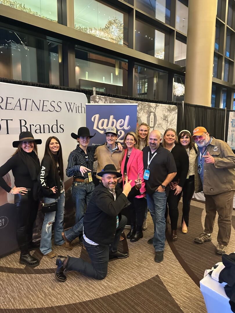A group poses together at an industry event in an additional photograph shared with Emily Reynolds Bergh’s interview.
