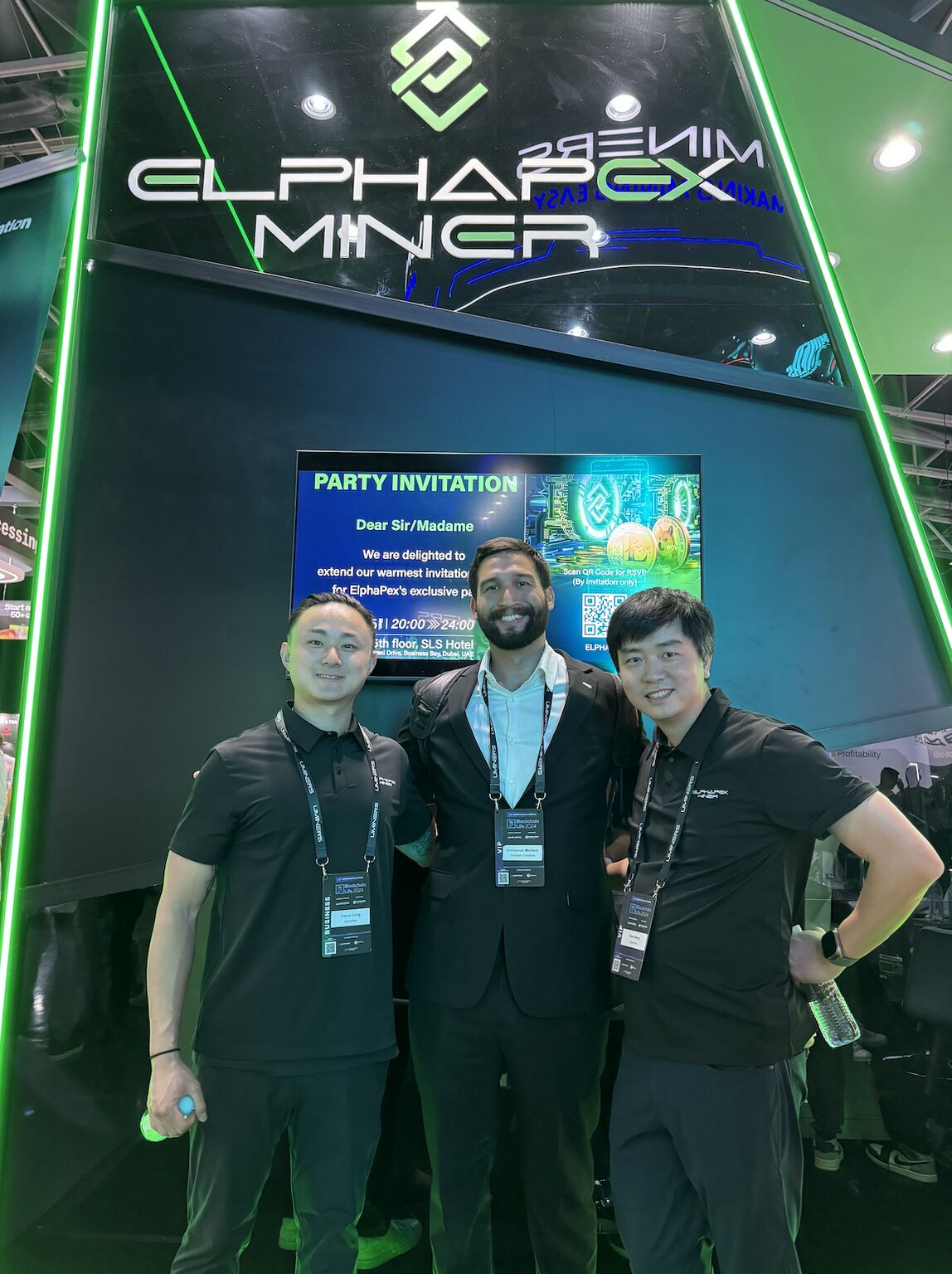 Emmanuel Montero at center with two attendees at an ElphaPex booth during Blockchain Life 2024