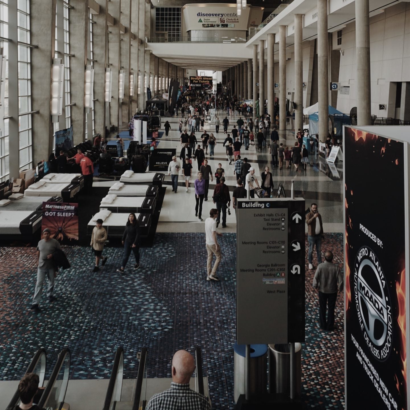 A busy convention hall in Atlanta with visitors, exhibits and registration traffic