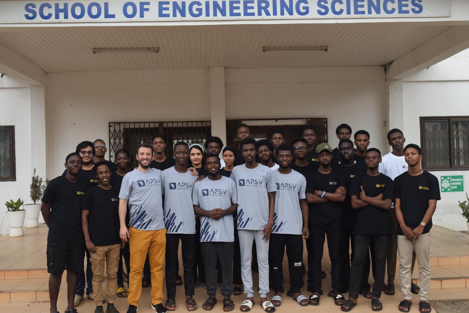 Emre Varol standing with A2SV students outside the School of Engineering Sciences at the University of Ghana