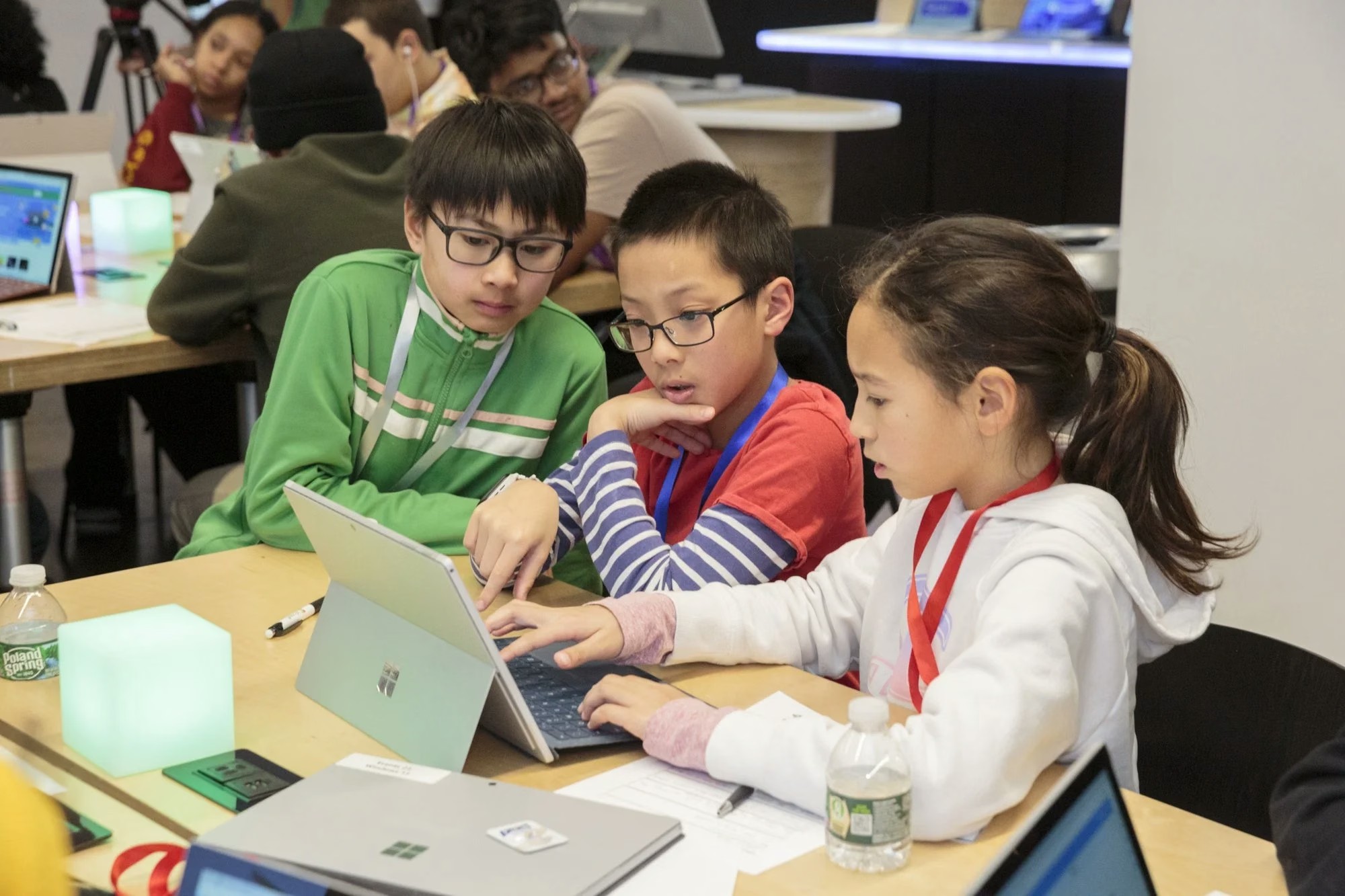 Young people collaborating around laptops at a game-making event