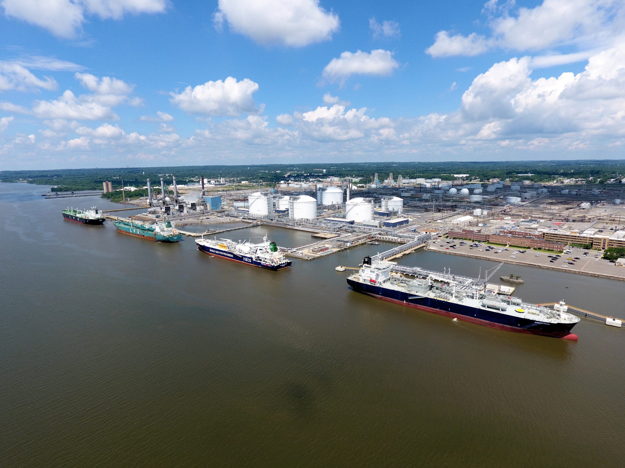Aerial view of docked gas carriers, storage tanks and piping at an Energy Transfer marine terminal