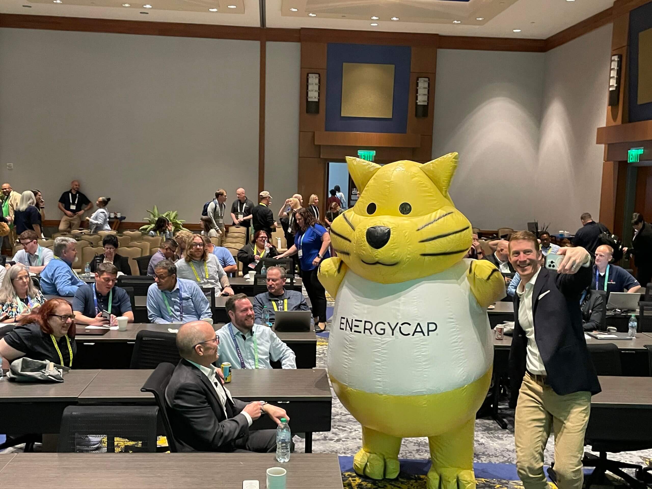 EnergyCAP customers and employees at Catalyst Atlanta 2025 with the company's large yellow cat mascot