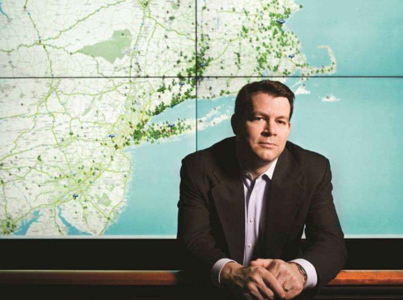 EnerNOC co-founder and former CEO Tim Healy in front of an energy network map