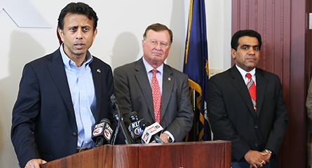 Bobby Jindal, University of Louisiana at Lafayette president Joseph Savoie and Enquero executive Hemant Asher at the 2014 announcement