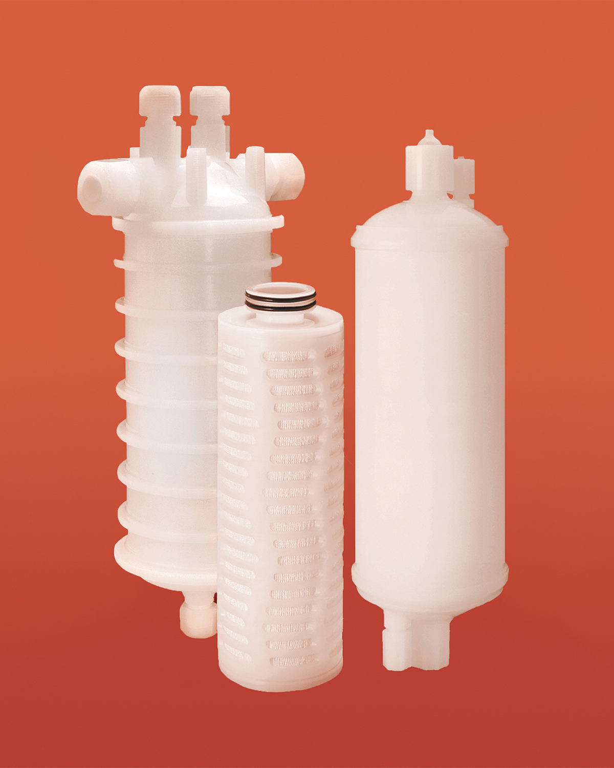Three white Entegris liquid filtration products against an orange background