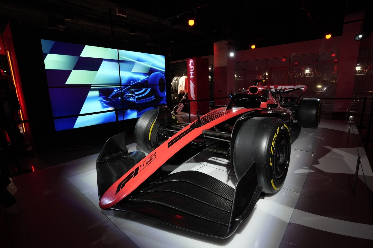Panelists on an EEG-produced stage surrounded by racing graphics and blue lighting