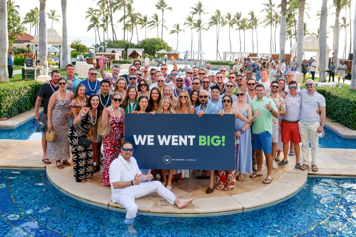 ServiceNow Winners Circle attendees gather beside a resort pool under palm trees