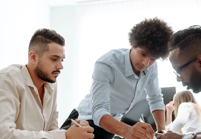 Illustrative photograph of people collaborating around a worktable, used on the Enterprise Minds website