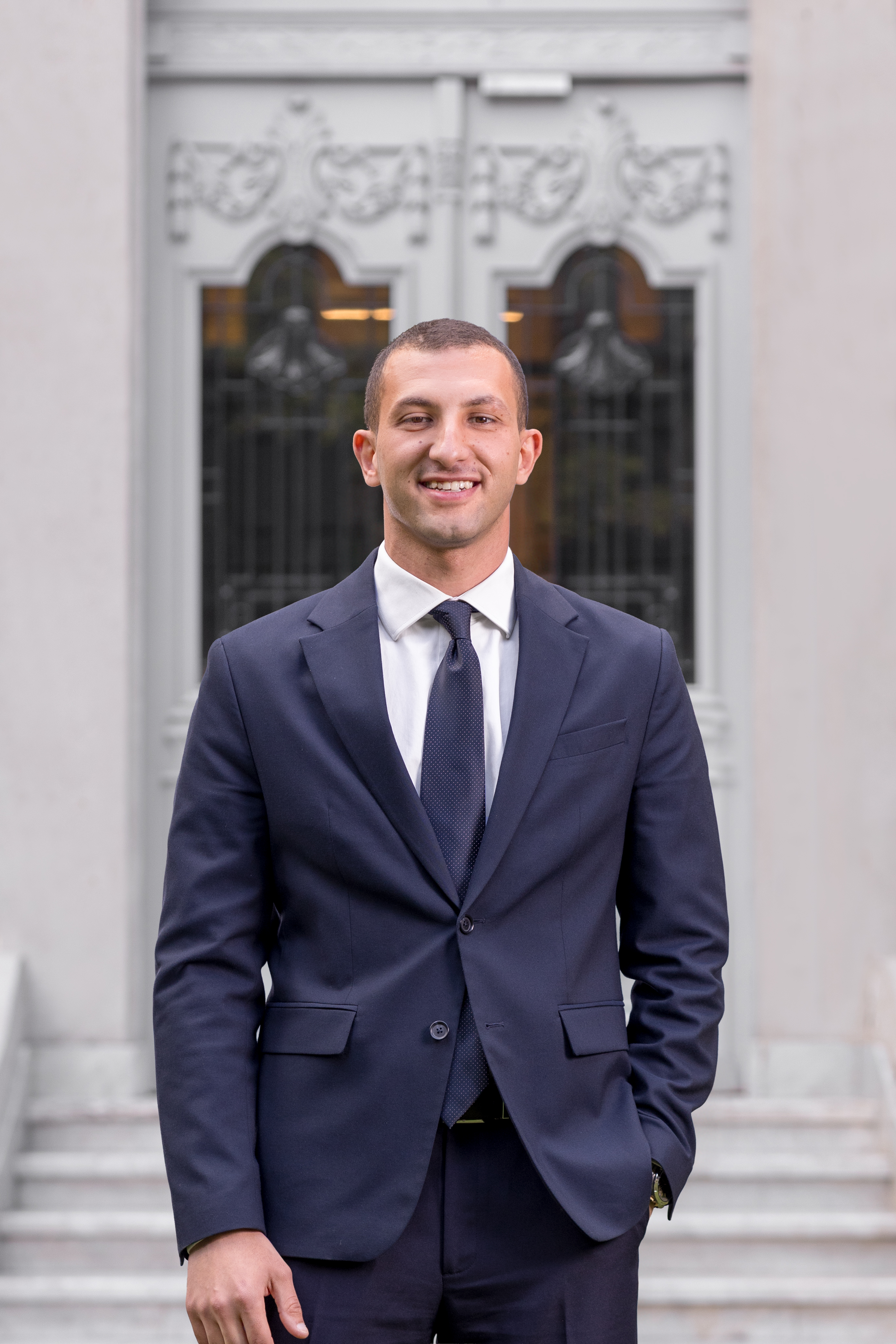 Mohamed Ehab, Entlaq co-founder and CEO, in a suit outside an ornate doorway