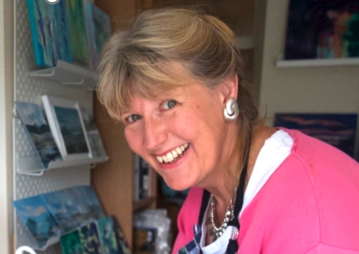 Artist and Kick Start participant Margaret Farrell with paintings in the background
