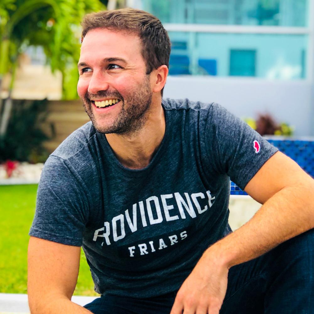 John Lee Dumas outdoors wearing a Providence Friars shirt