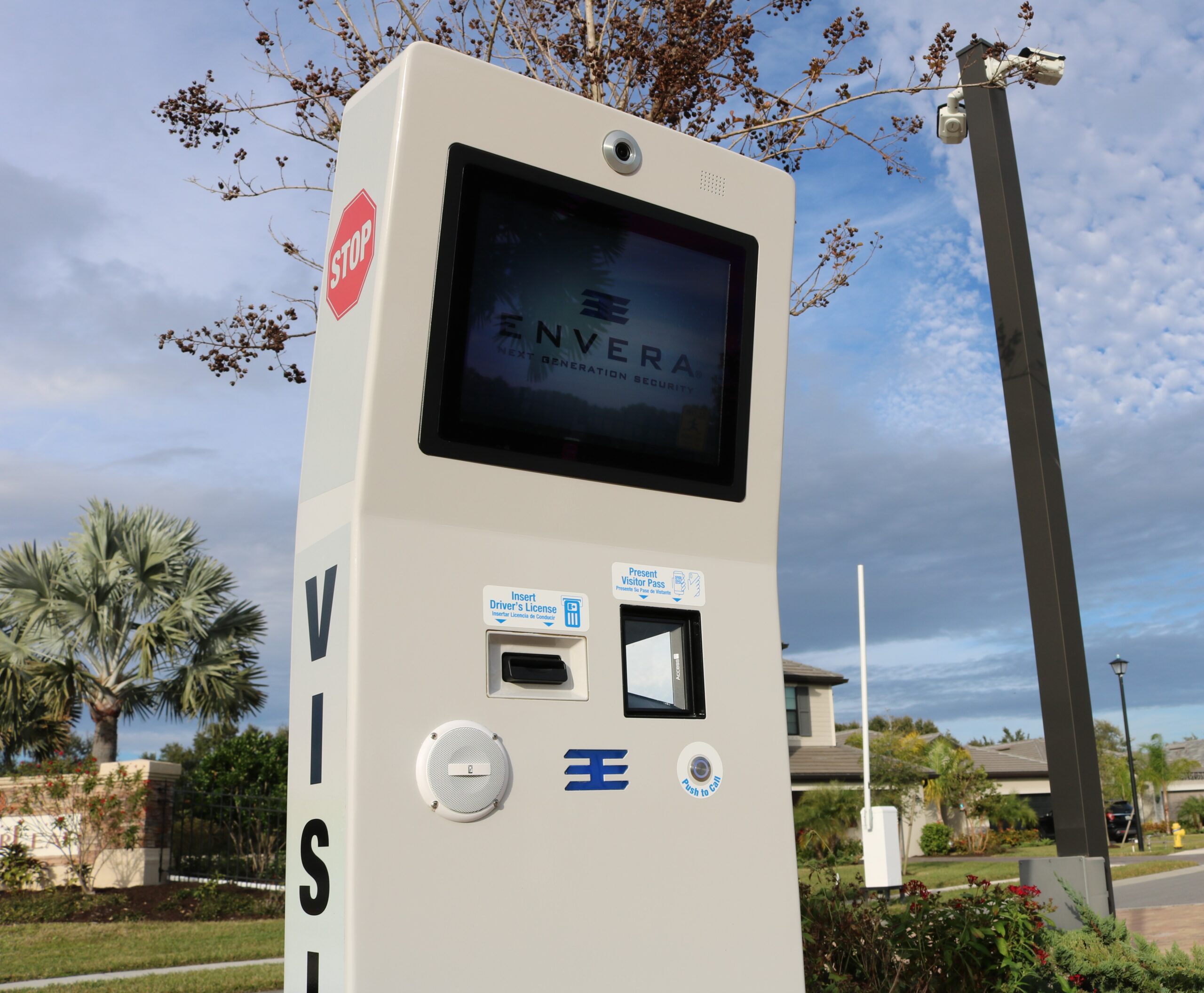 Envera visitor kiosk with touchscreen, identification slot and call button at a community entrance