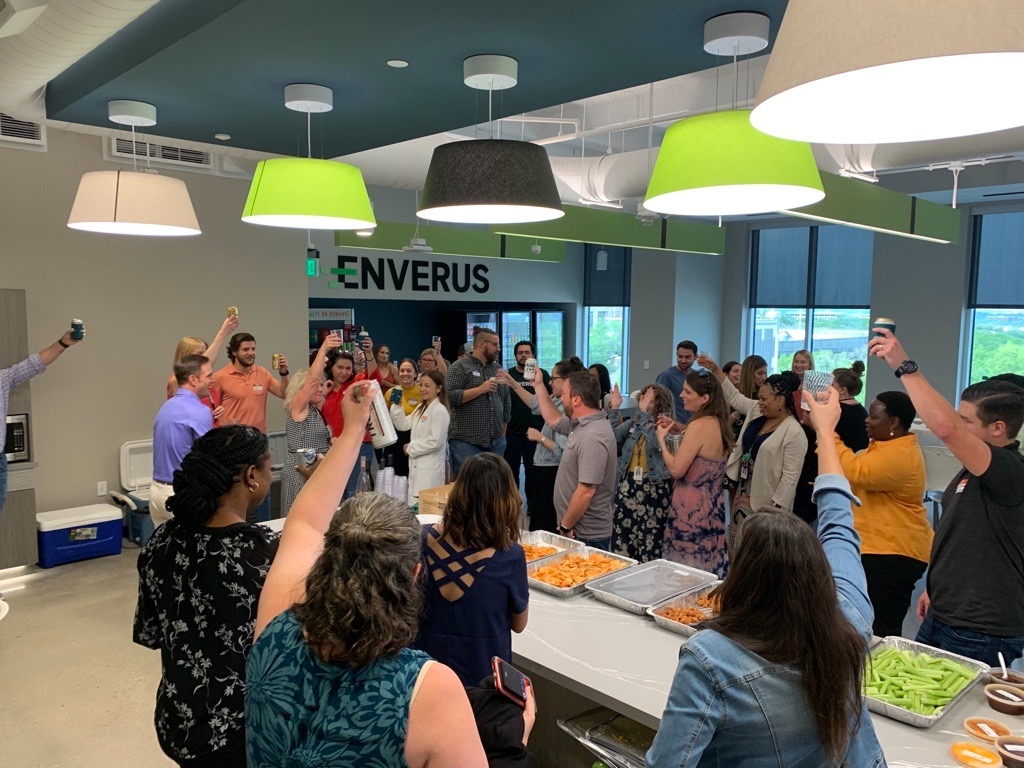 Enverus employees gather around a table at the Austin office