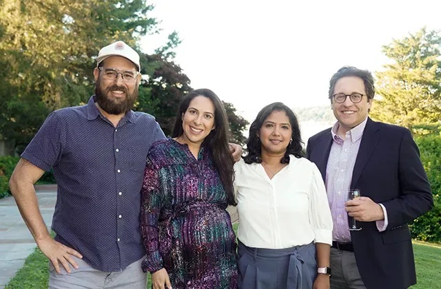 Four Envisagenics team members photographed together outdoors