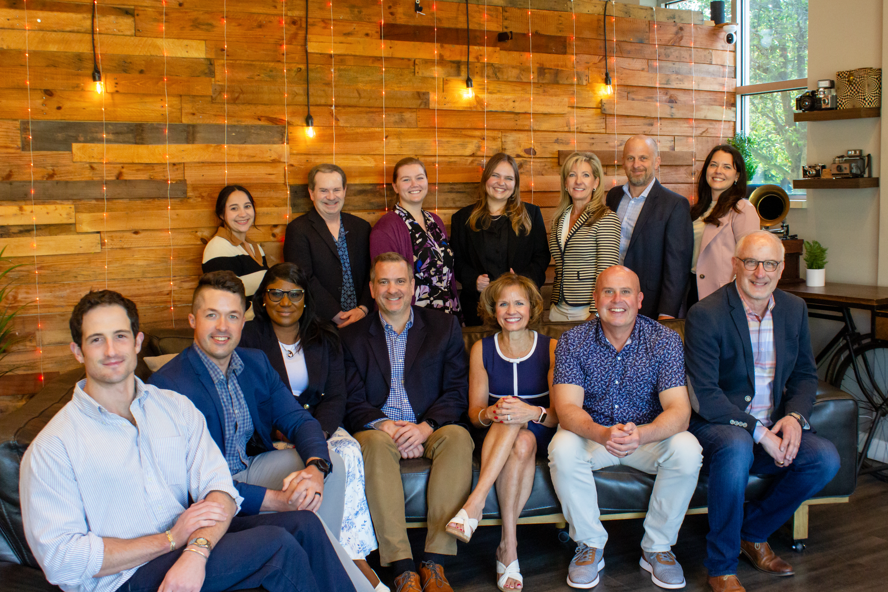 Members of the Envision Health team gathered in a warm, wood-panelled office