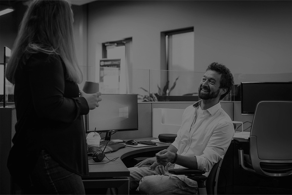 Two eOne Solutions colleagues talking in the Fargo office