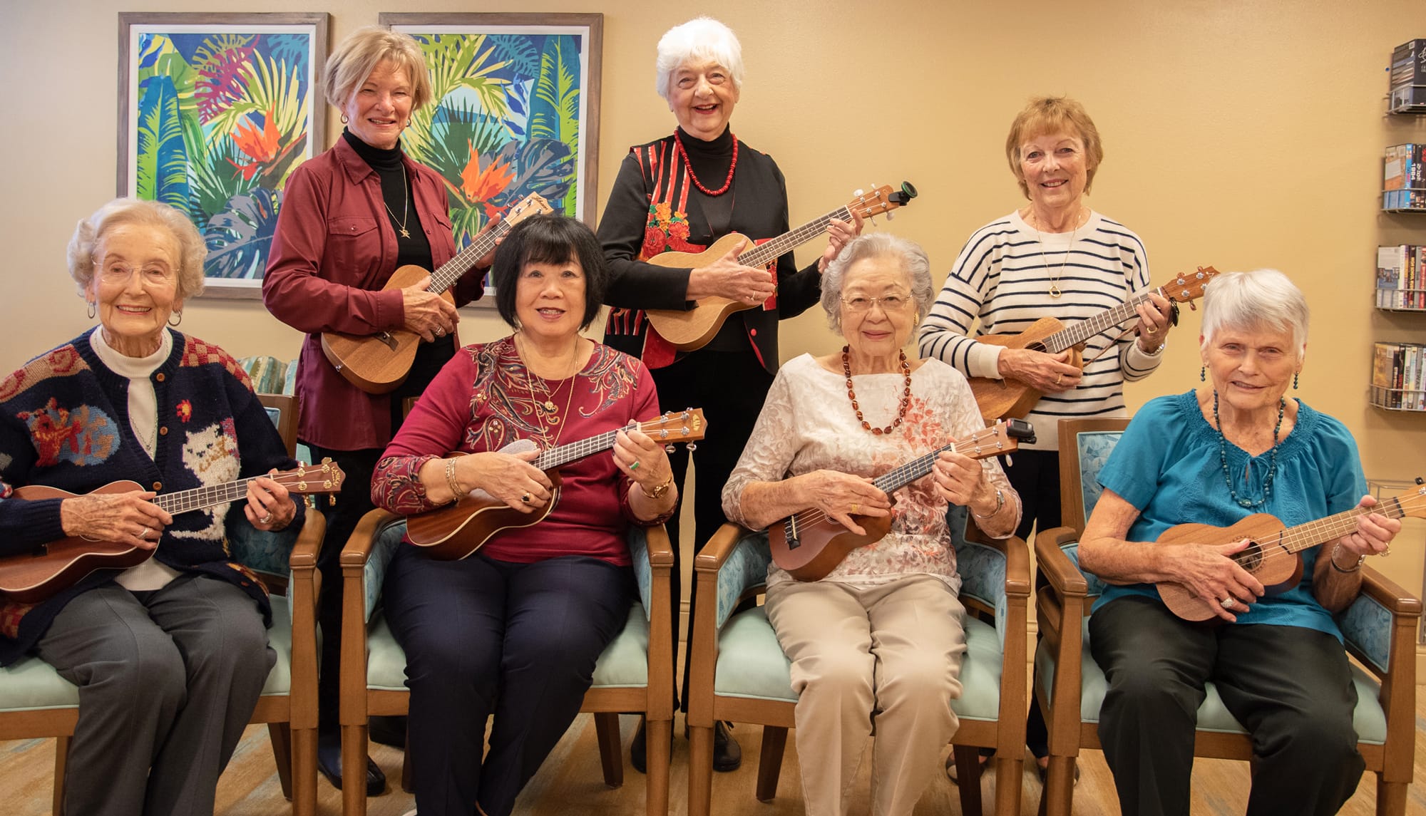 Seven women at The Covington pose together holding ukuleles