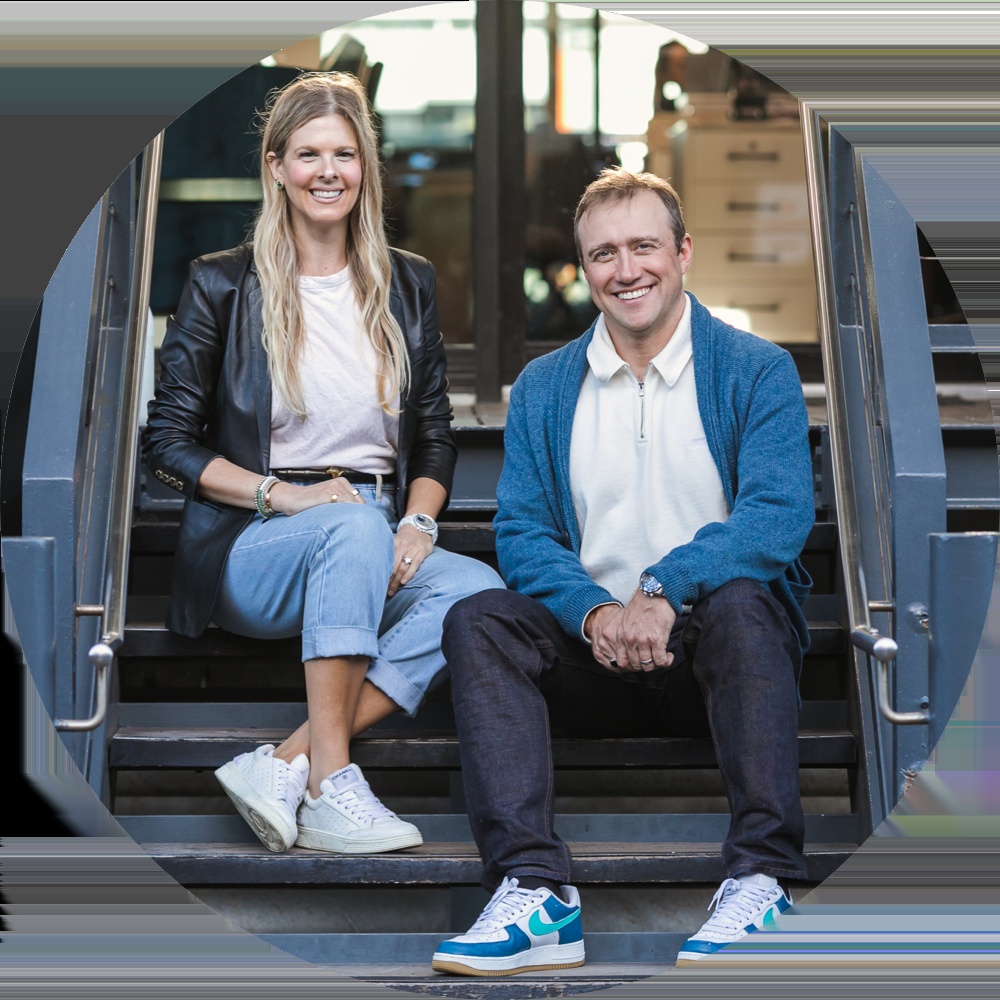 eQ8 co-founders Alicia Roach and Chris Hare seated together on steps