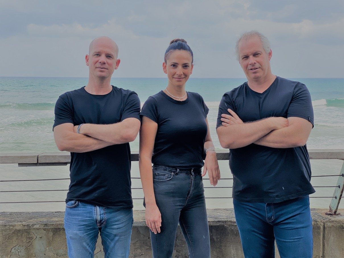 Bites co-founders Eran Heffetz, Tal Nagler Almog and Hagai Horovitz standing beside the sea