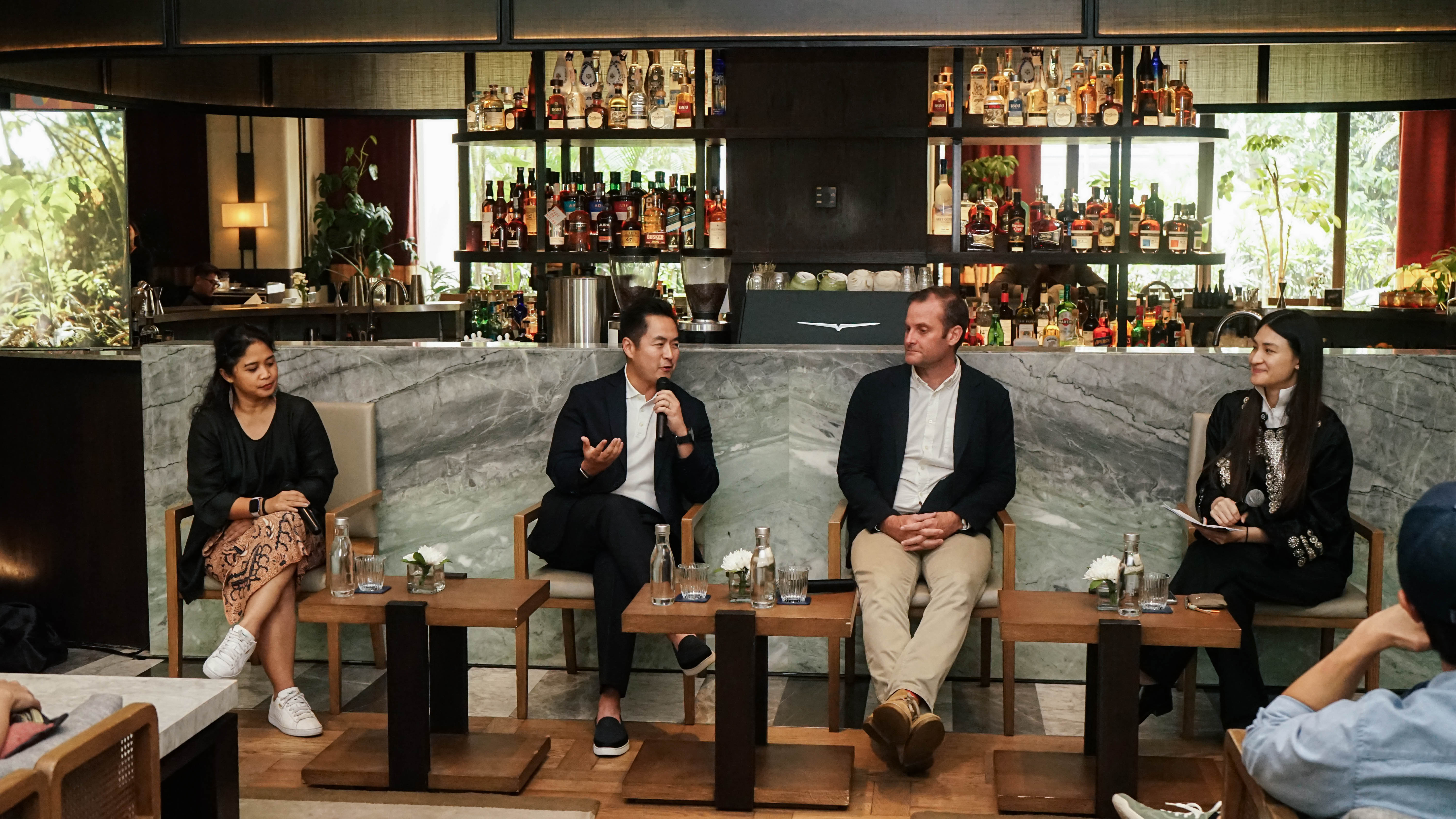 Erastus Radjimin speaking alongside fellow panelists at a sustainability discussion in Jakarta