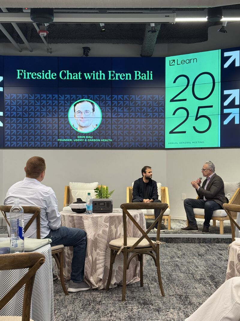 Eren Bali, seated at center, joins a fireside discussion at the Learn 2025 Annual General Meeting.