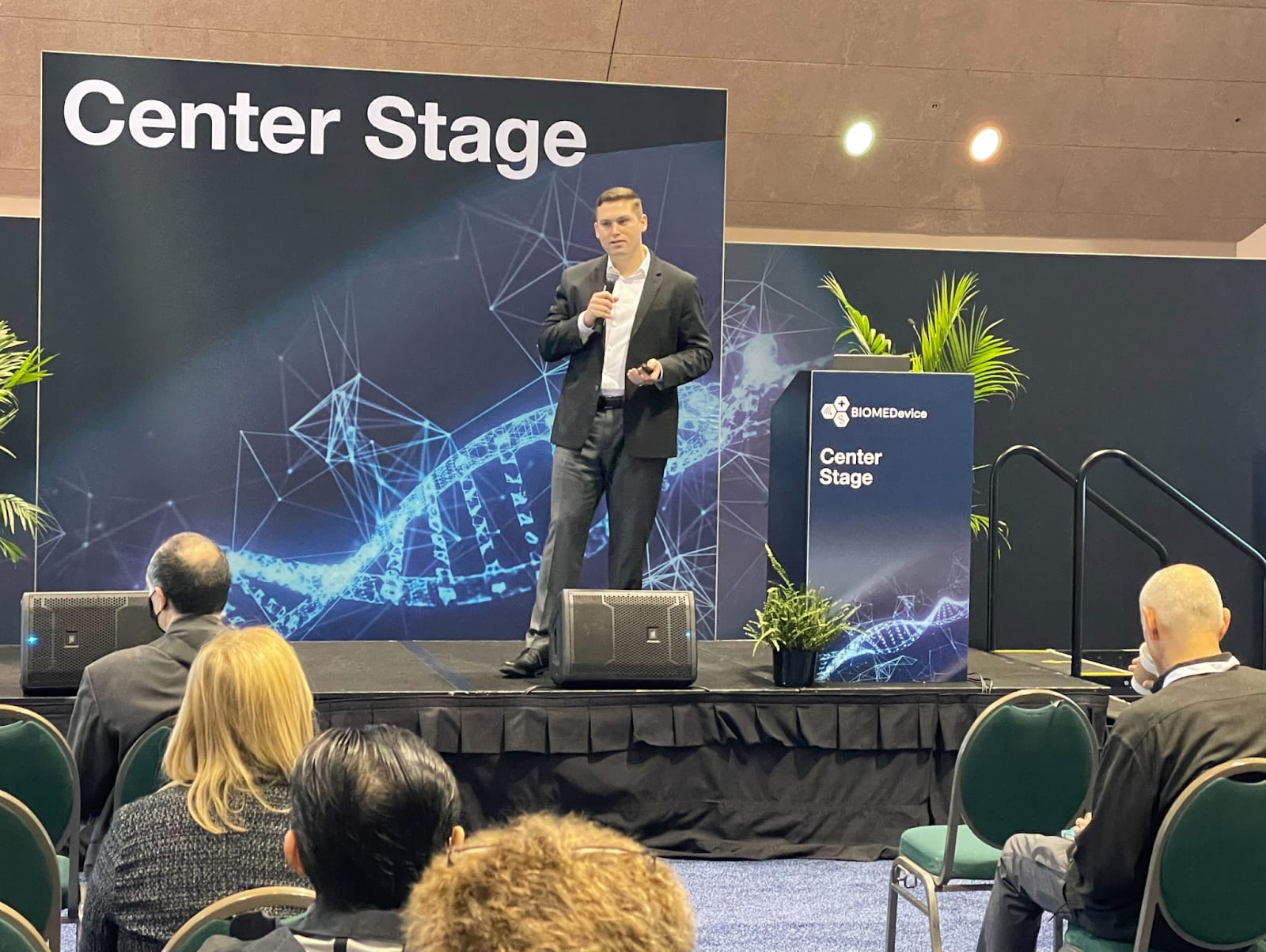 Erez Kaminski speaking onstage at a medical technology conference