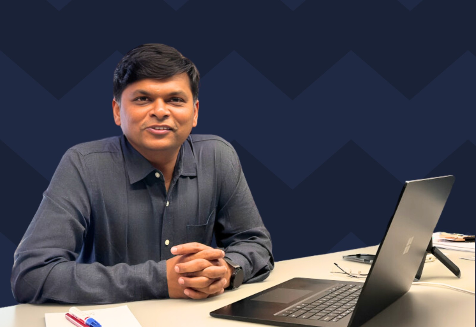 Ergode founder and CEO Rupesh Sanghavi seated at a desk with a laptop