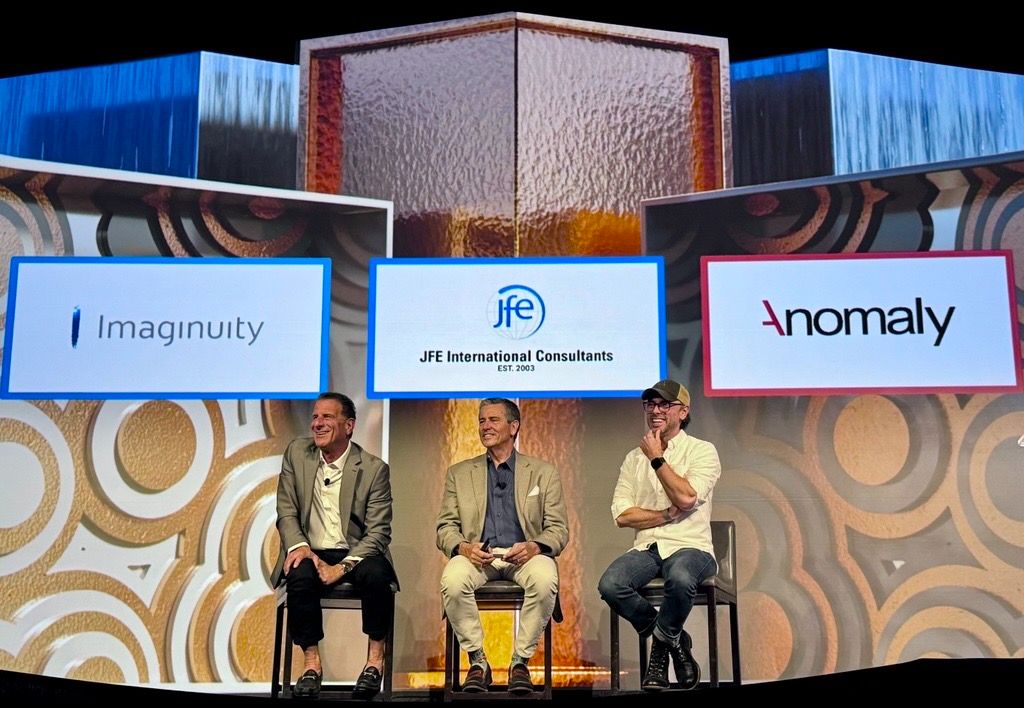 Eric Damassa, at right, smiles onstage during an ANA panel with J. Francisco Escobar and Charlie Calise