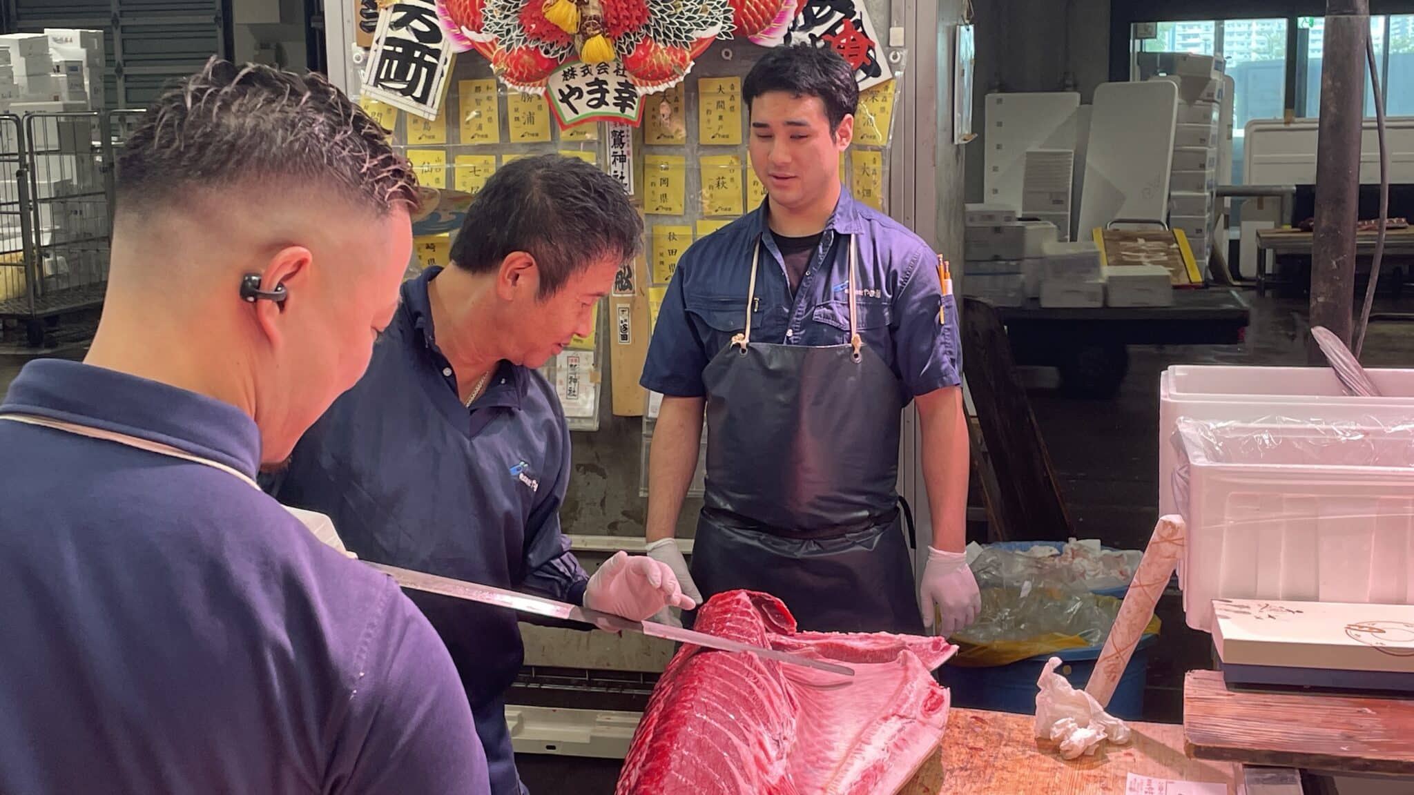 Workers handling and cutting tuna at Yamayuki in Japan.