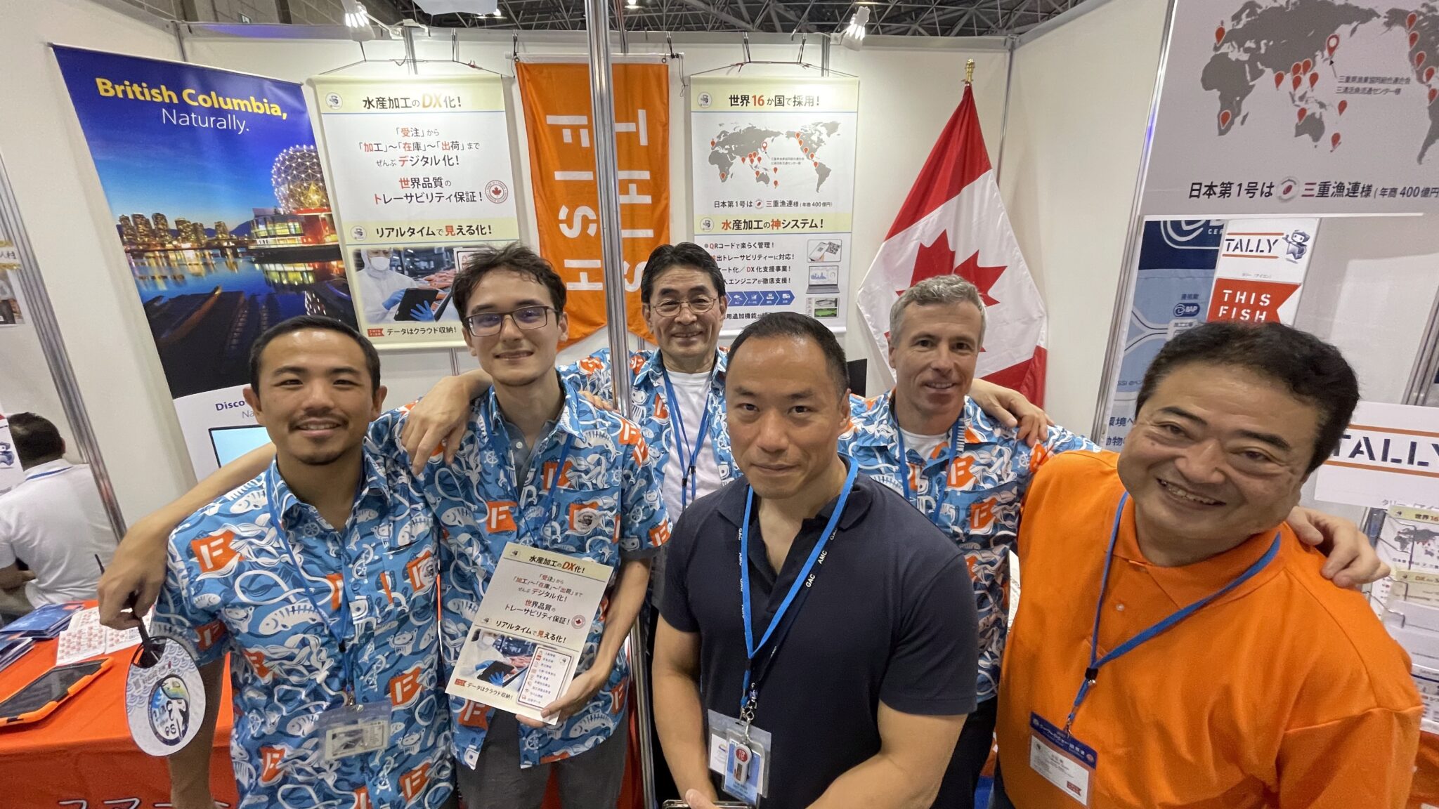 Eric Enno Tamm, second from right, with ThisFish colleagues and Japanese business partners at an exhibition booth.