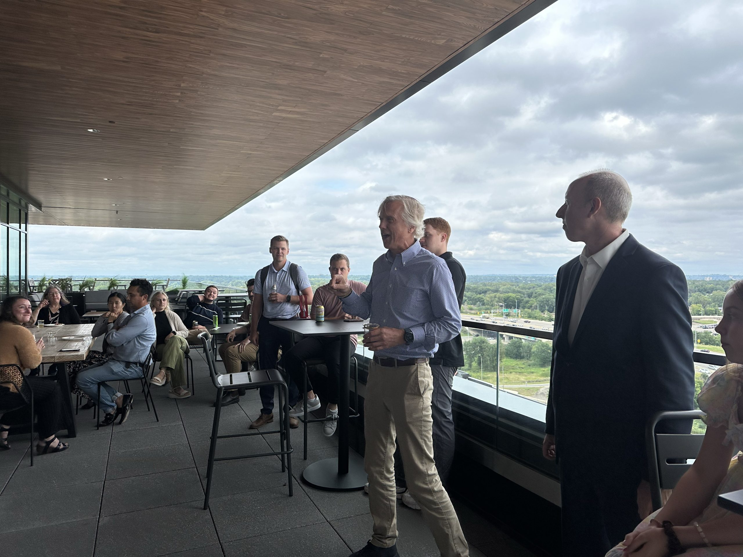 Eric Ewald speaking to colleagues at an outdoor company gathering