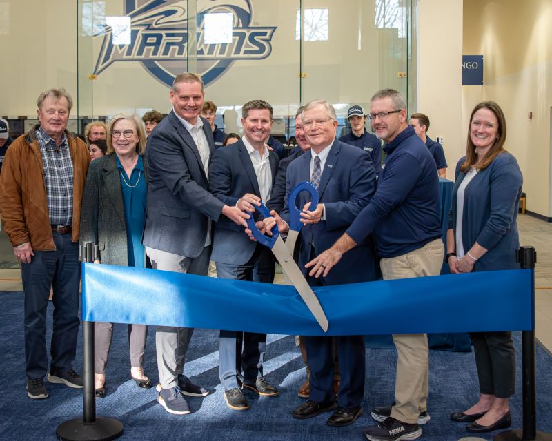 Eric Nyman participating in the ribbon cutting for the performance golf center at Virginia Wesleyan