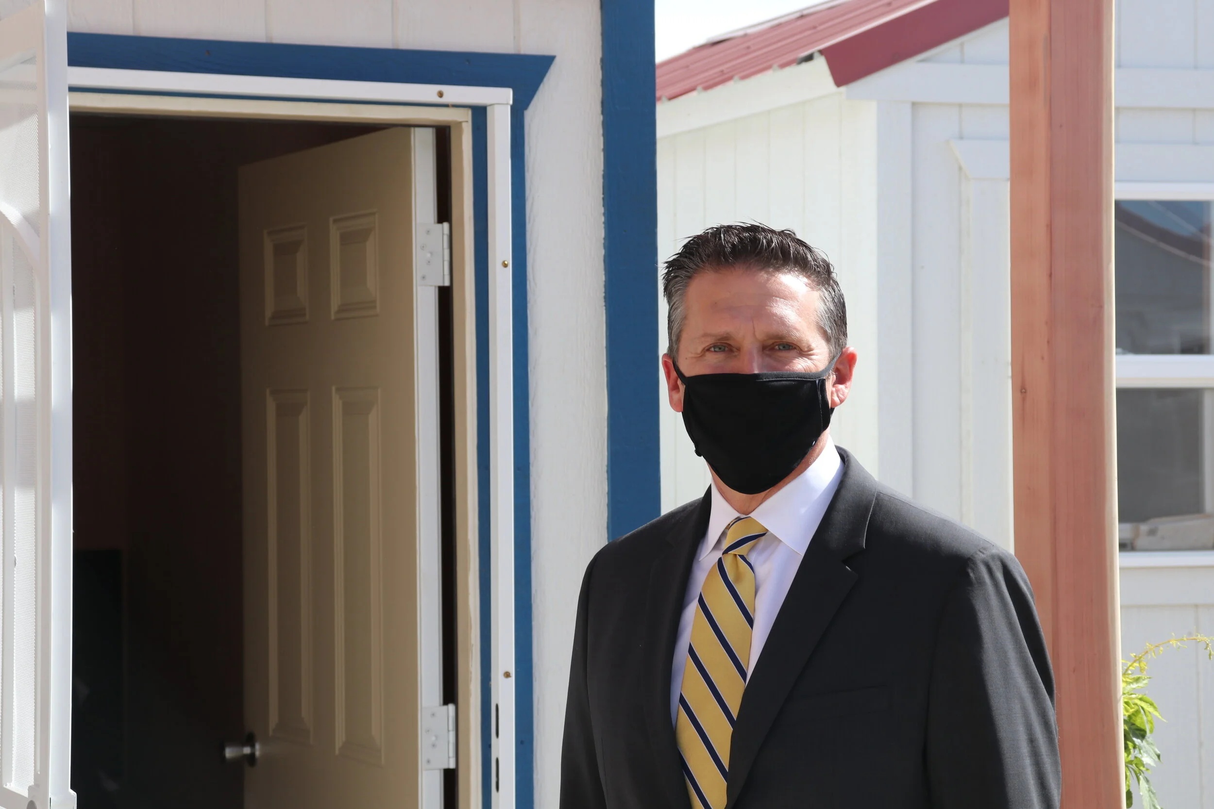 Eric Schmacker standing beside an open doorway at the HopeSprings housing project in Reno