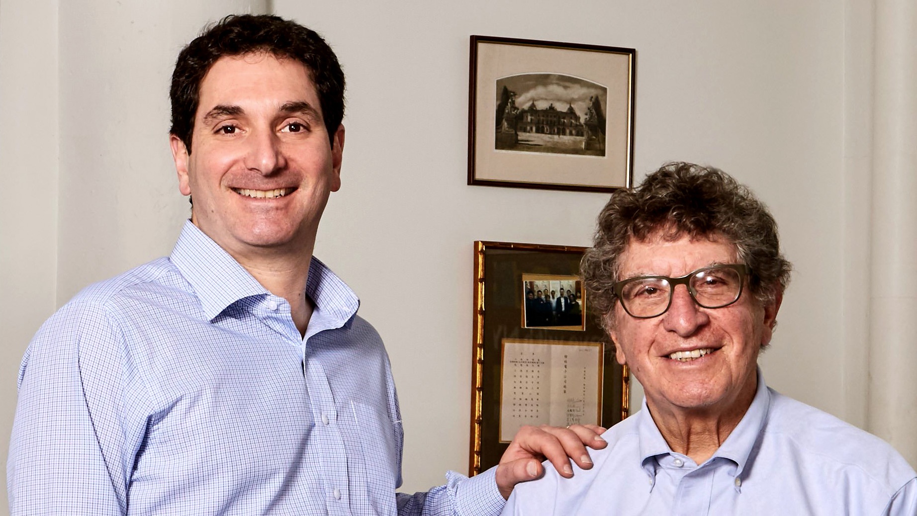 Eric Sills, left, with his father Larry Sills in an office