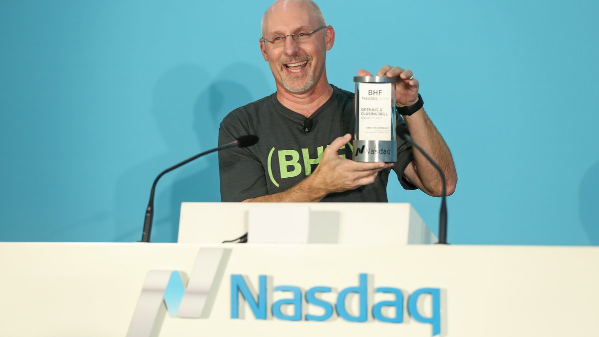 Eric Steigerwalt smiles while holding a Nasdaq opening and closing bell plaque at Brighthouse Financial's 2017 debut