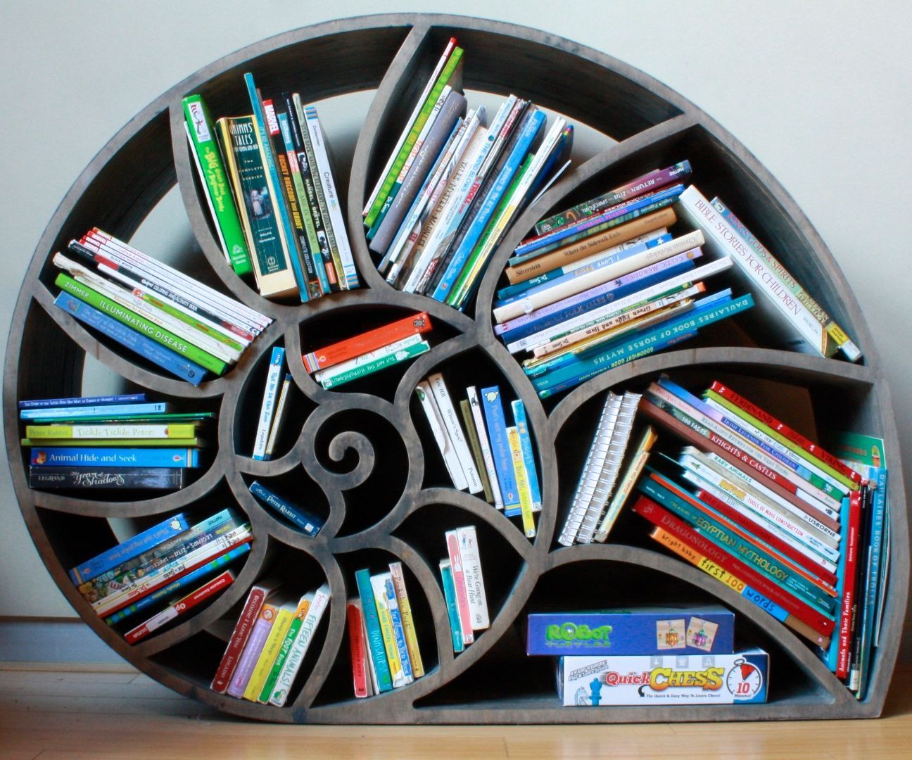Eric Wilhelm’s spiral-shaped nautilus bookshelf filled with children’s books